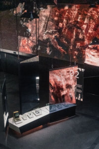 Exhibition space at Haus der Digitalisierung in Tulln, featuring a large curved LED wall with dynamic data visuals, interactive displays, and modern architectural elements.